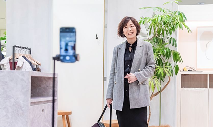 ストアインフルエンサーがスマホでコーディネート写真を撮影している様子